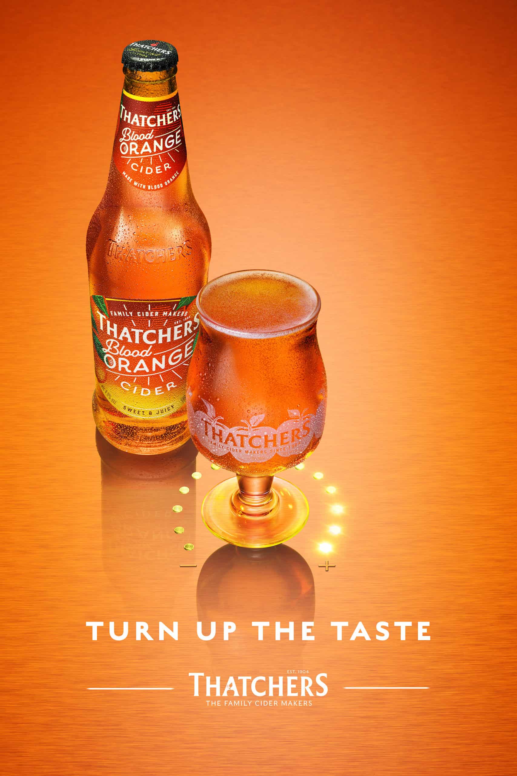 Vibrant image of a chilled glass and bottle of Thatchers Blood Orange Cider from a drinks photoshoot by advertising photographer Jonathan Knowles, shot in his London studio.
